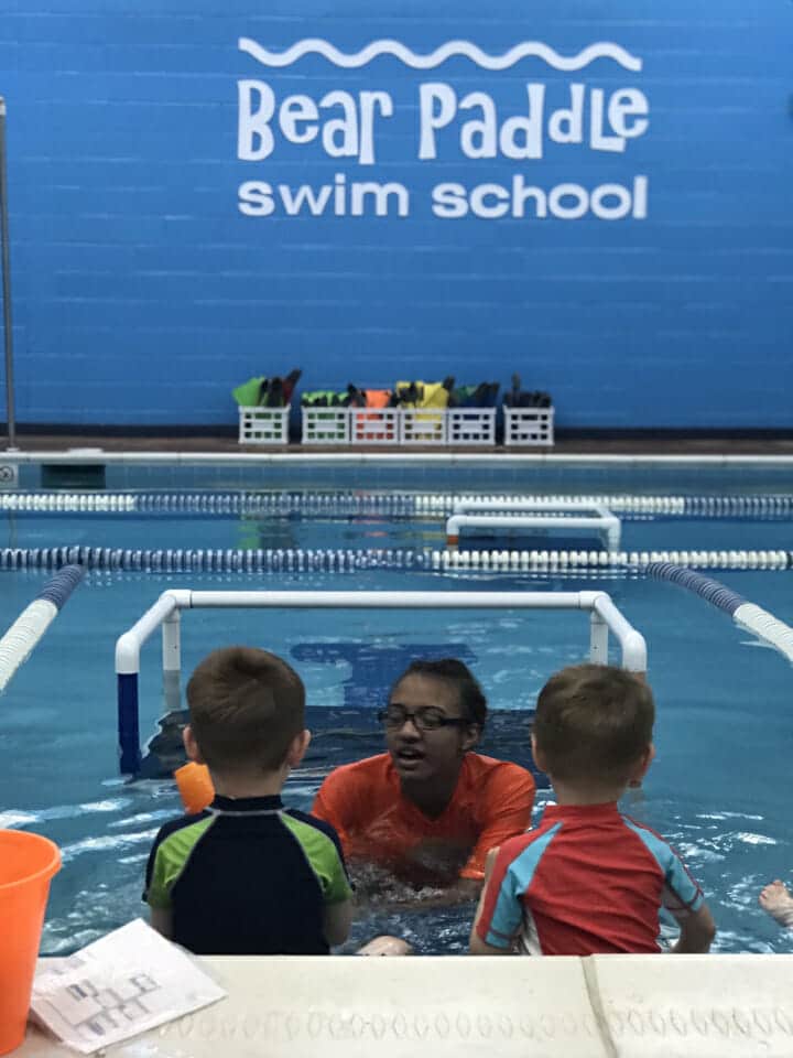 swim coach and her students in a swim class