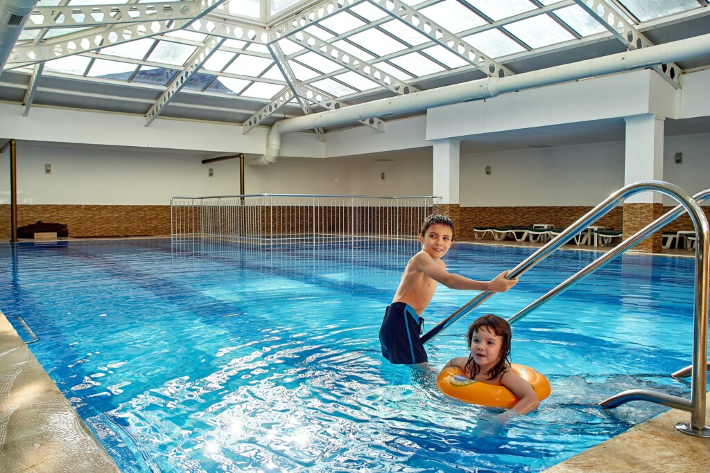 two kids playing in the pool for swim class