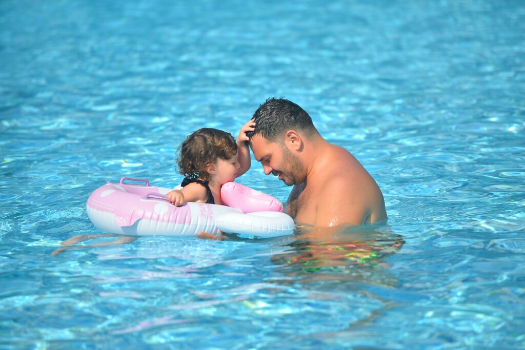 Father and daughter in a pool