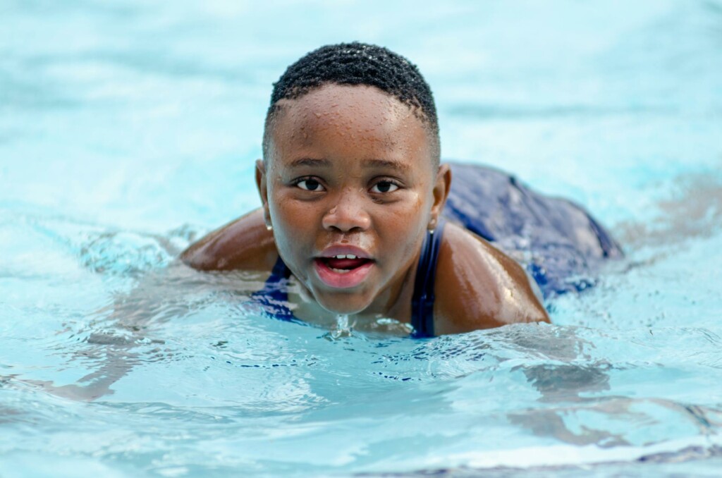 a kid in a swimming pool