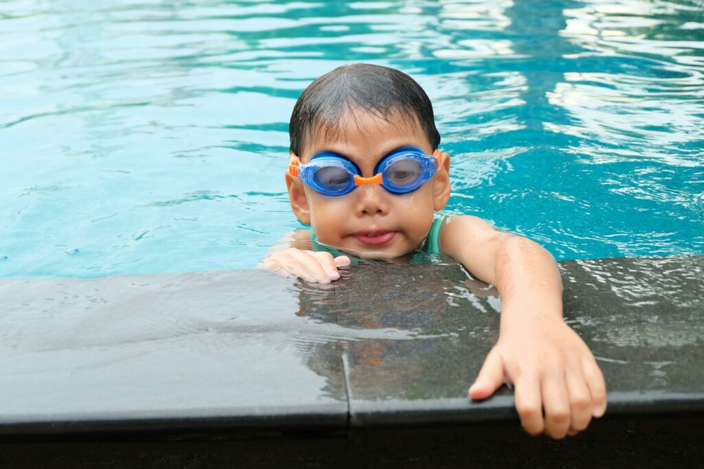 little boy on the edge of a swimming pool