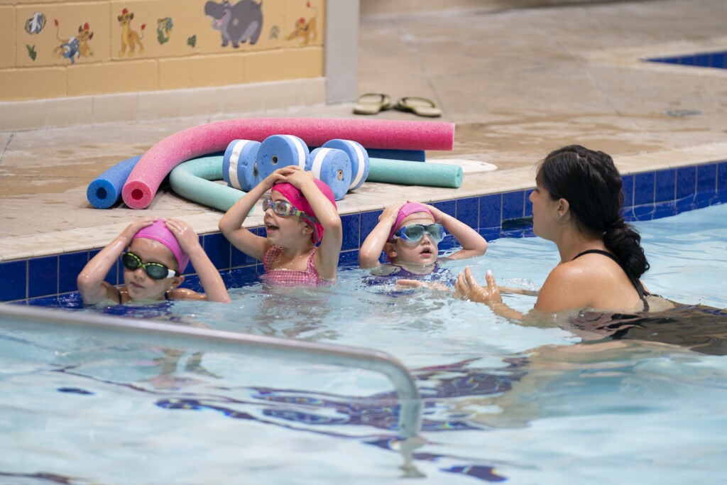 little girls wearing swimming gear in a pool