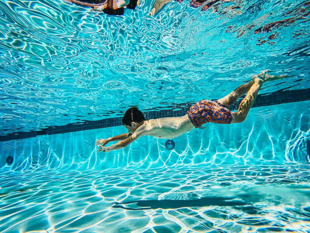 child swimming in pool